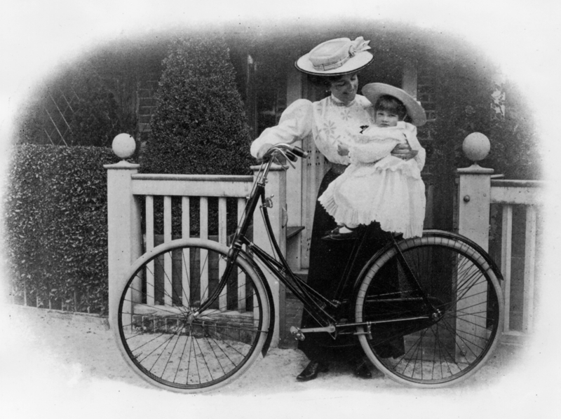 A Mother, Child, and Bicycle | Getty Images Photo by National Motor Museum/Heritage Images